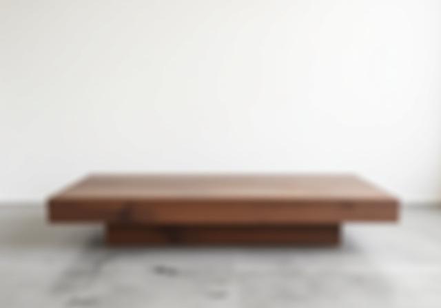 A handcrafted modern minimalist coffee table made of walnut